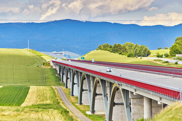 Autostrada highway in Europe. D1 magistal near Spišský hrad, arched bridge. Motorway viaduct bridge, Spis region, Slovakia. Green summer fields, hills of Tatra mountains. - 686871526