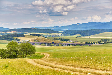 Slovakia summer landscape. Green summer fields, meadows, hills of Tatra mountains. Travel in vacations. Rural Road in Spis region, Slovakia. Spissky hrad national park - 686871542