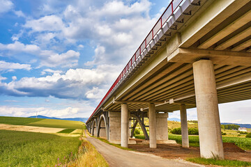 Motorway viaduct bridge, Spis region, Slovakia. Autostrada highway in Europe. D1 magistal near Spišský hrad, arched bridge. Green summer fields, hills of Tatra mountains. - 686871550