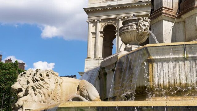 Close-up on Fountain Saint-Sulpice on a sunny day with the Church of Saint-Sulpice in the background - Paris, France