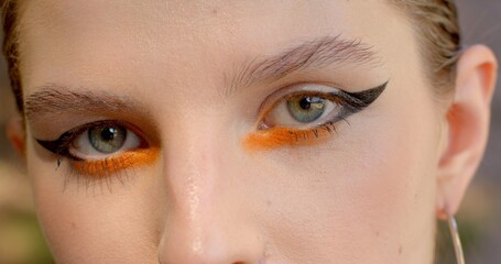 Black arrows make-up. Close-up of girl eye is created to emphasize the beauty and details of the...