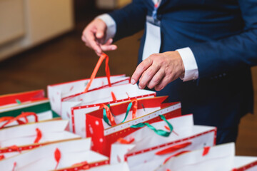 New Year corporate gifts and souvenirs for company employees, Christmas party surprise gift bag, gift giving at office work, red green and white paper bags, presents exchange with colleagues at work