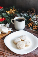 Traditional Christmas polvorones, nevaditos, mantecados on plate with cup of coffee for holidays