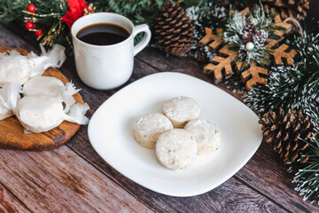 Traditional Christmas polvorones, nevaditos, mantecados on plate with cup of coffee for holidays