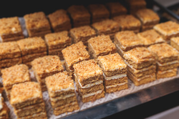 Beautiful multicolored decorated baked sweet tasty candy bar dessert selection with cake, pie and pastries catering banquet table on a kids children party, coffee break buffet at a conference