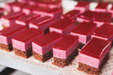 Beautiful multicolored decorated baked sweet tasty candy bar dessert selection with cake, pie and pastries catering banquet table on a kids children party, coffee break buffet at a conference