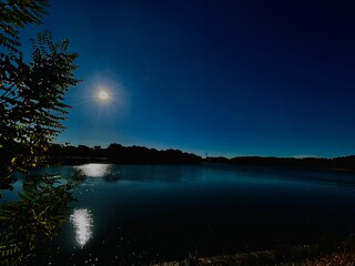 view of the lake in the night with moonlight