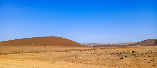 Beautiful natural view of moroccan desert landscape on sunny day with beautiful blue sky. Moroccan southern regions hills.