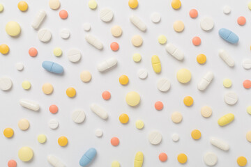 Flat lay with different medical pills and capsules on color background