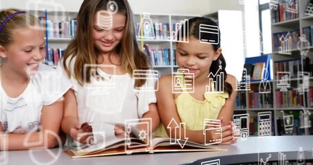 Animation of multiple icons over diverse female girl reading book with friends in library at school - Powered by Adobe