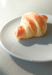 Delicious crusty croissants on a plate.