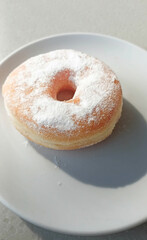 Photo of White Powdered Sugar Donuts on a plate ready to eat
