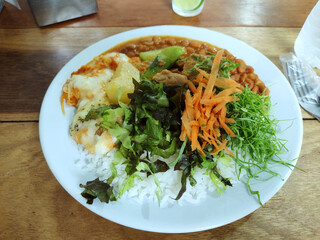 Traditional Brazilian meal known as Prato Feito on the wooden table restaurant.
