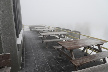 Freezing cold, frozen empty bench in Uludag, Bursa - Turkiye. frozen sitting area, frozen wooden picnic table