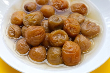 Pickled plums in white plate