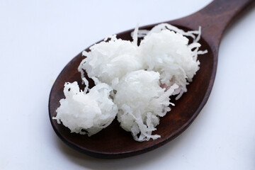 Sweet coconut balls, crispy coconut candies (Maprao Gaew). Thai traditional dessert