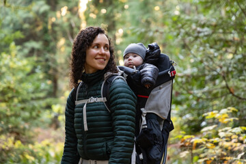 Mother Hiking with Baby in Backpack Carrier in Canadian Nature.