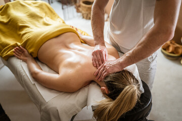 Obraz na płótnie Canvas unknown woman enjoy neck massage at beauty spa male therapist