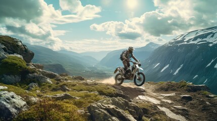 Man riding a dirt bike on top of a mountain