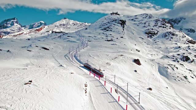 Aerial view of Swiss cog railway train ride to the Gornergrat Observation Platform in Zermatt. View from above of the train with tourists at the Matterhorn mountain in the Alps in Europe.