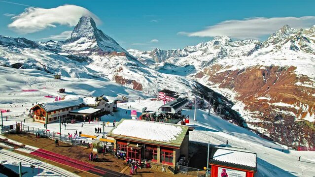 Aerial view of a ski resort with cable car in Zermatt Riffelberg mountain station. Tourists enjoying vacation at the Matterhorn Swiss mountain in the Alps in Europe at the Riffelhaus 4-star hotel.