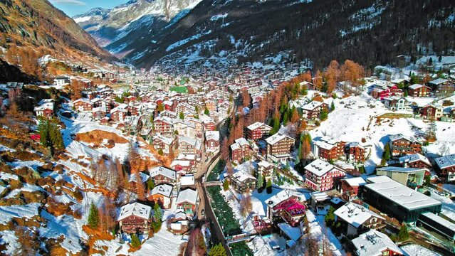 Drone view of colourful houses in Zermatt Matterhorn, Swiss Alps, Switzerland. Aerial View of mountain resort renowned for skiing, climbing and hiking.

