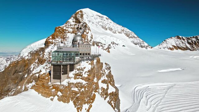 Scenic view from above of Mountaintop Sphinx observatory at Jungfrau station. Aerial view of the highest accessible railway in Europe, Swiss Alps in Switzerland.