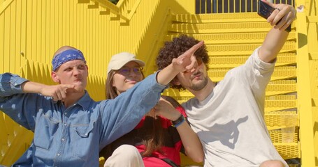 Young adults together one girl with two boys. Generation Z grown up in a digital age Joyful youth capturing happy moments in a selfie, celebrating friendships and carefree moments with radiant smiles.