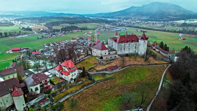 Aerial view of Swiss heritage site of national significance Gruy&egrave;res Castle. View from above of hilltop fortress covered by snow in Switzerland.