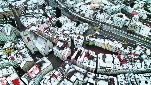Aerial view of Alpine City Chur with a tower clock and colourful houses. The capital of the Graub&uuml;nden canton covered with snow in eastern Switzerland. 