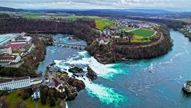 Aerial panoramic view of Rhine Falls, Rheinfall and railway Bridge in Switzerland. View from above of the largest plain cascading waterfalls in Europe and Schloss Laufen Castle.