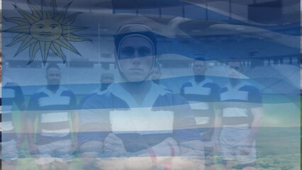Animation of uruguay flag over team of diverse male rugby players standing together at rugby field - Powered by Adobe