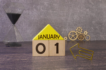 1 January inscription on wooden calendar on background of trendy 2024 colors of yellow and gray.