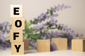 EOFY, End of Financial Year text. wood cubes and white background.