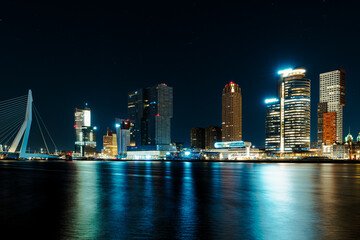 A mesmerizing night panorama of the city of Rotterdam, showcasing its modern high-rise architecture...