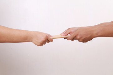 Bribery. A hand gives a bribe to other hand. Side view. White background. Close up. Concept of...