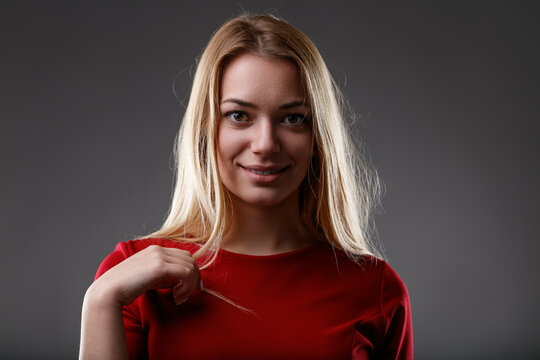 Knowing smile, subtle hair twist