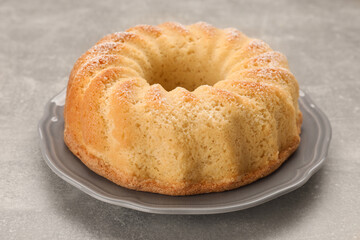 Delicious freshly baked sponge cake on gray table, closeup