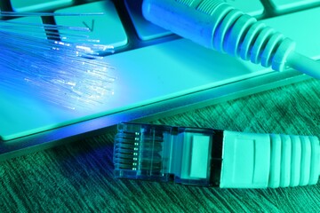 Optical fiber strands transmitting color light near cable with modular connector and computer...