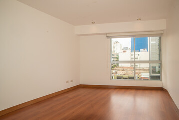 habitacion de departamento con acabados en parquet y closet empotrado