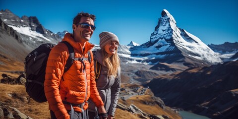 Mature couple hiking in Alps mountains in Switzerland, matterhorn switzerland
