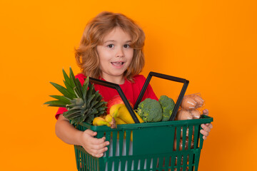 Food store. Funny child shopping with shopping basket. Sales and shopping. Kid boy with shopping...