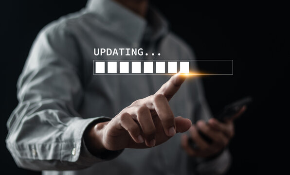 Hand touching downloading progress bar and installing update process. Software updates or operating system upgrades to keep your device up to date with enhanced functionality in new versions.