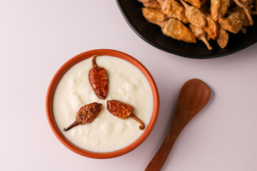 Bowl of homemade sour cream curd yogurt Dahi fresh herbs curry leaf Kerala India. Dairy product...