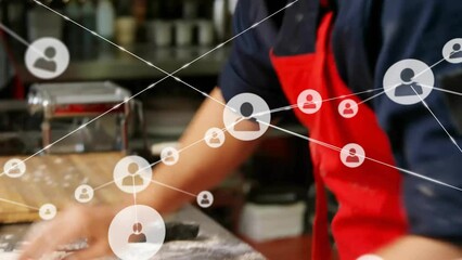 Animation of network of connections over caucasian male chef rolling dough - Powered by Adobe