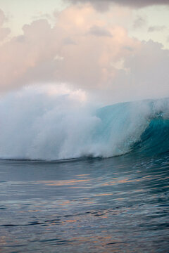 Blue and golden waves at sunset over the ocean in Tahiti 