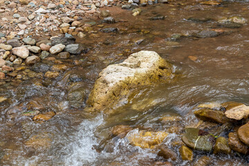Mountain river spring season with sand and stone shoals along the banks.