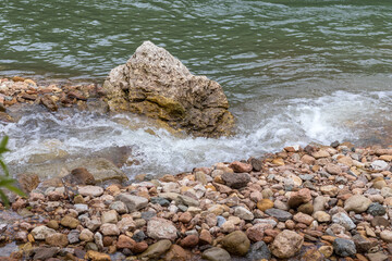 Mountain river spring season with sand and stone shoals along the banks.