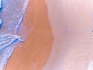 Aerial view of Waves crashing on sandy shore,Sea surface ocean waves background,Top view beach background