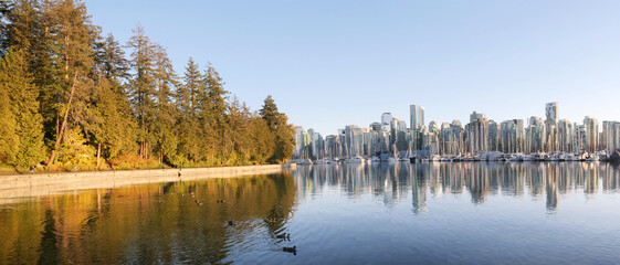 Panorama of the skyline of Vancouver as seen from Stanley Park during a golden hour evening in the fall in British Columbia, Canada